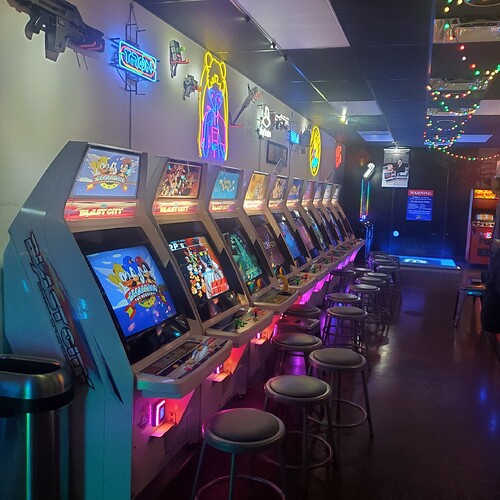 line of brightly lit arcade cabinets